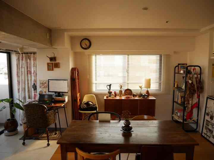 暖かいブラウン調のダイニングとリビング、ミッドセンチュリーモダン家具とホームオフィスが調和した雰囲気のあるインテリア