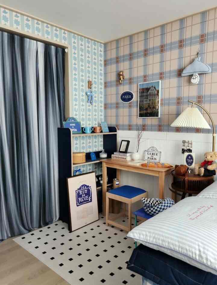 Pastel tone wallpaper and blue accents in cozy bedroom featuring desk, stools, and carpet with Nordic style