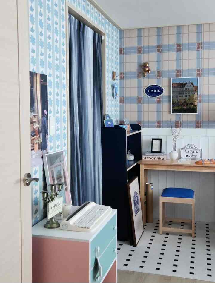 Cozy entrance interior featuring wood console table in blue and white tones with Paris-themed decorative items