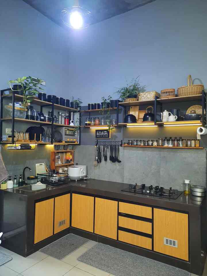 Dapur semi industrial yang terinspirasi dari pinterest. 
Awalnya dapur ini hanya dapur standar developer yang terdiri dari meja kecil dengan sink kecil. Lalu, kami renovasi menjadi dapur letter L dengan lemari bawah dan rak dinding terbuka. Kombinasi warna lemari dan rak kayu muda dengan frame besi hitam cocok untuk konsep dapur semi industrial. 
Kami juga mengganti granit meja dapur dan backsplash dengan granit stone grey ukuran 60 x 60 cm supaya memudahkan dalam pembersihan dan maintanance.  

#kitchenset #kitchensetminimalis #kitchensetalumunium #rakdindingdapur #lemaridapuracp #mydreamkitchen #kitchenrenovation #kitchenstyling 