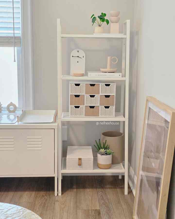 White and natural-toned home office space featuring minimal furniture and plants with a clean, cozy atmosphere