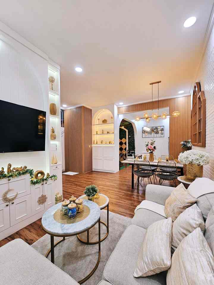 White and wood tone living and dining room for four-person household featuring gold accents with a natural modern atmosphere