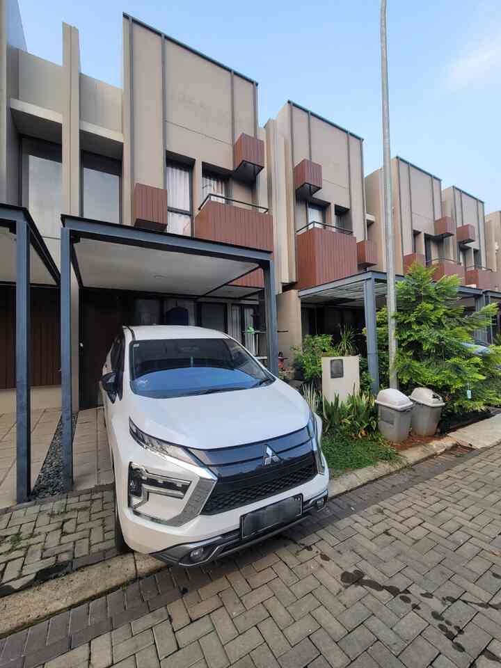 White and brown tone compact townhouse facade in a neat, modern cluster housing environment