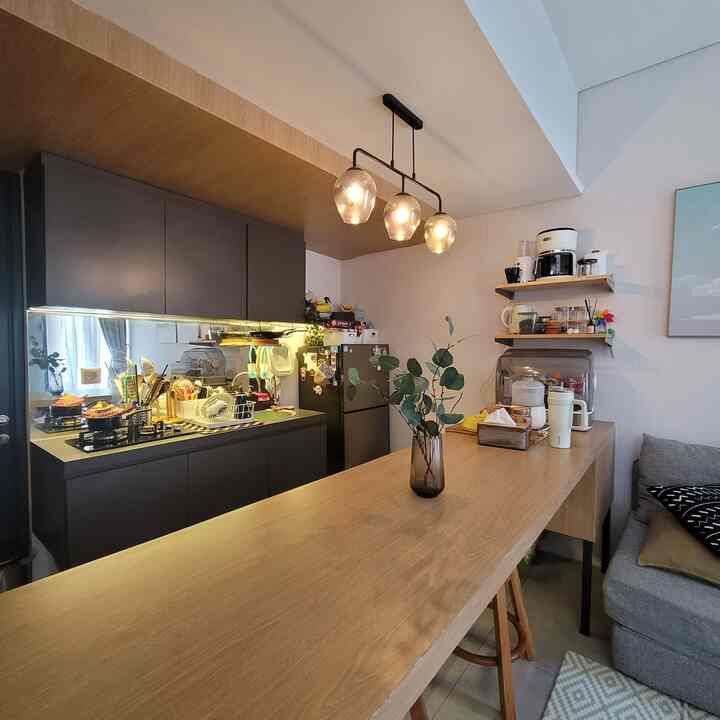 Gray and wood-tone kitchen and dining room with a modern, minimal ambiance