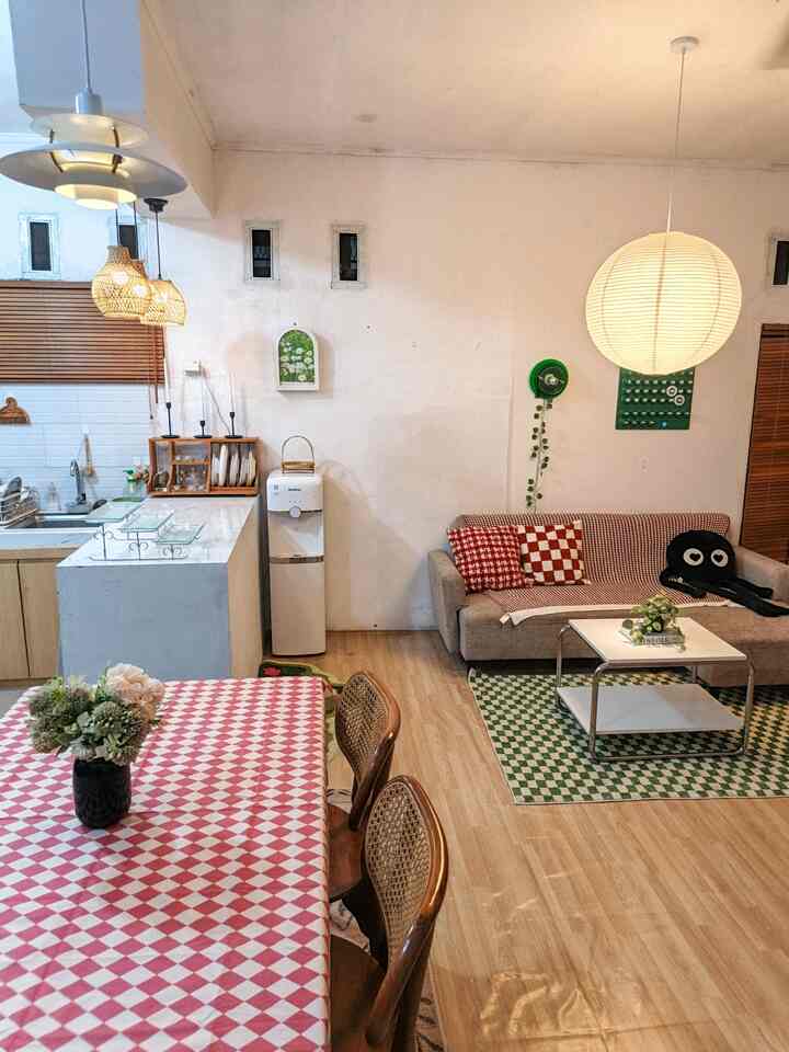 White and brown toned living and dining room featuring checkered tablecloth and cushions in a cozy space