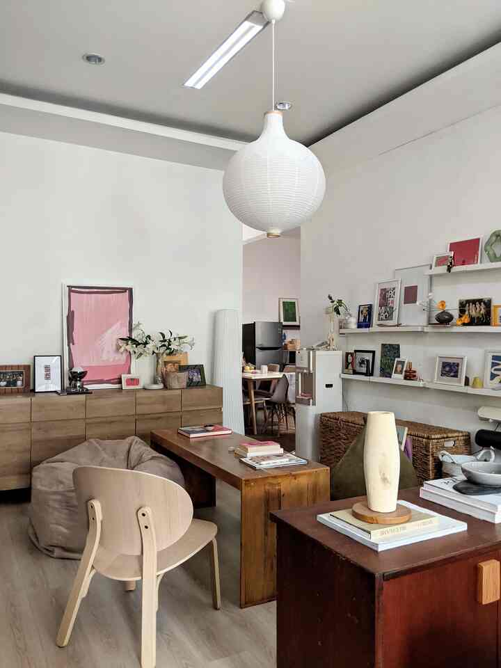 Natural-tone living room featuring wooden furniture and a bean bag chair in a cozy, well-organized setting
