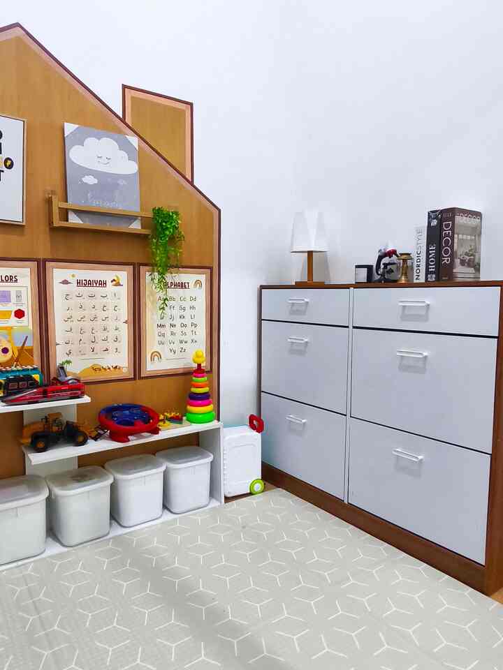 White and beige toned kids' room featuring storage cabinets and educational posters with a cozy atmosphere