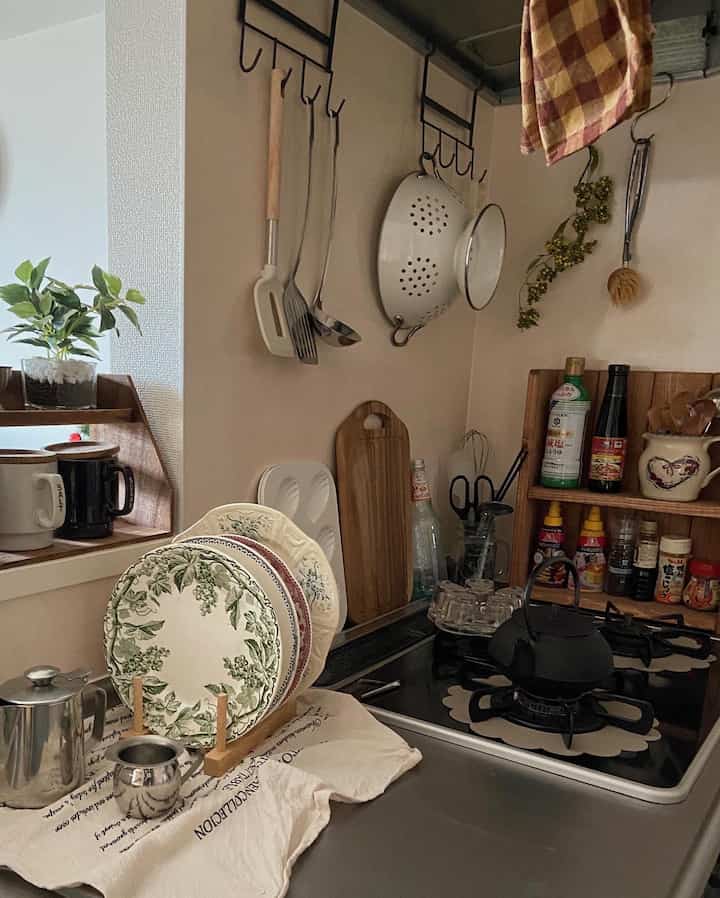 A natural kitchen space with beige and wood tones, featuring organized kitchen utensils and a kettle, evoking a cozy atmosphere