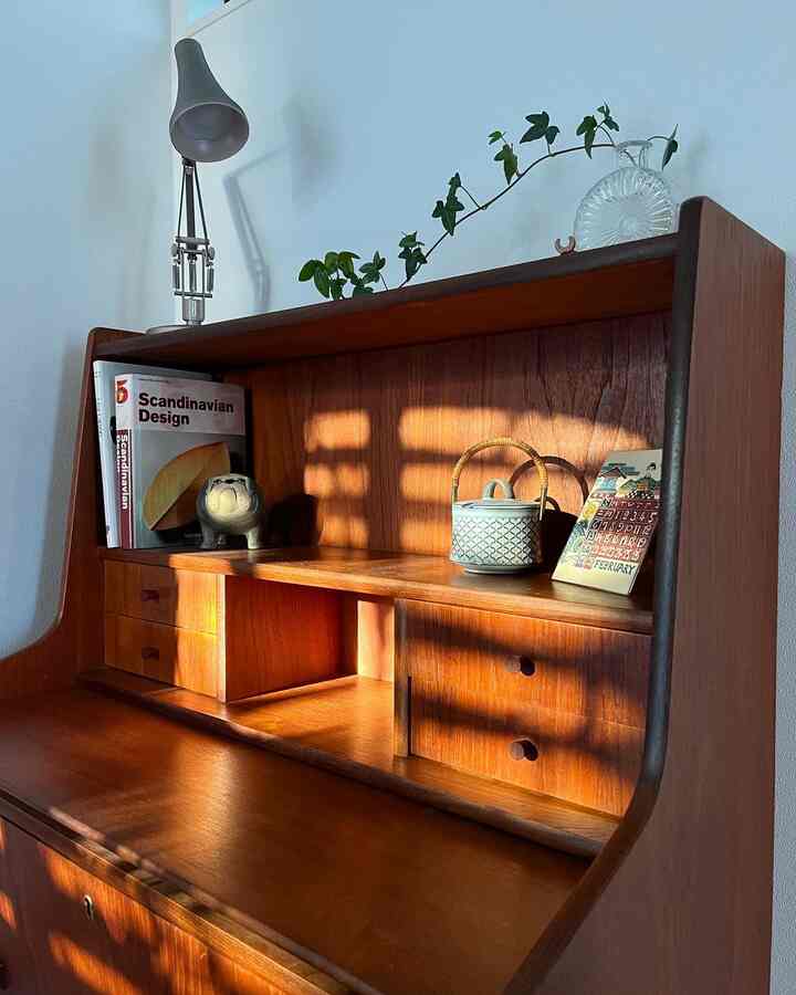A warm brown wood tone desk bathed in natural light creating a cozy and natural modern atmosphere