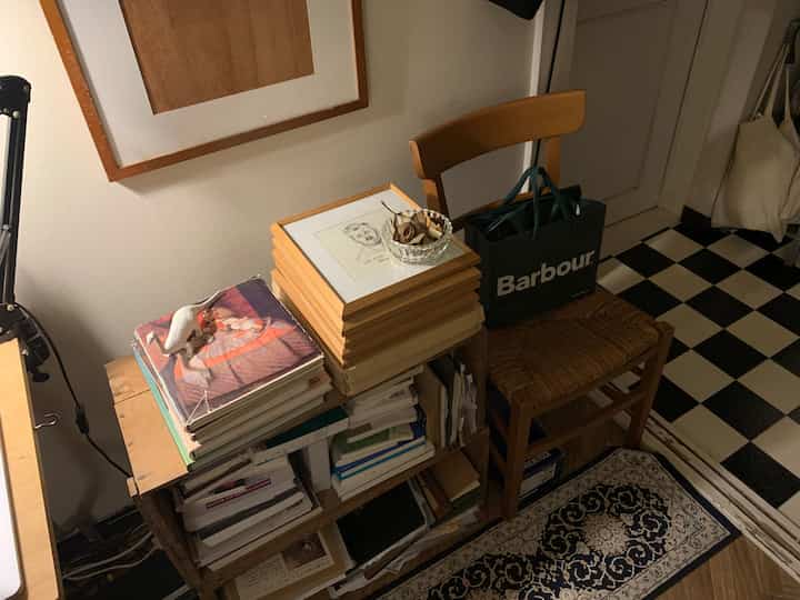 木目調とヴィンテージ感のある玄関スペース、収納アイデアが光る木箱棚と椅子が配置された温かみのある雰囲気のインテリア