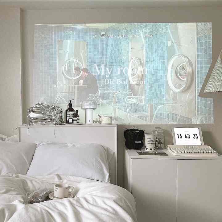 White-toned bedroom featuring a neatly arranged bed and dresser with a modern and cozy atmosphere