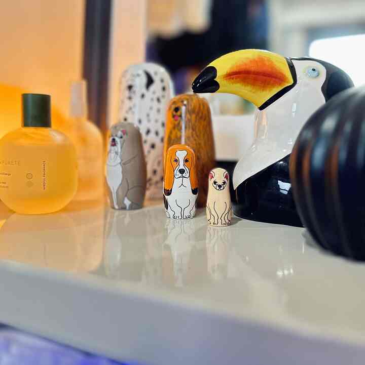 黄色の照明と動物モチーフのマトリョーシカが置かれた白いテーブルの印象的なインテリア