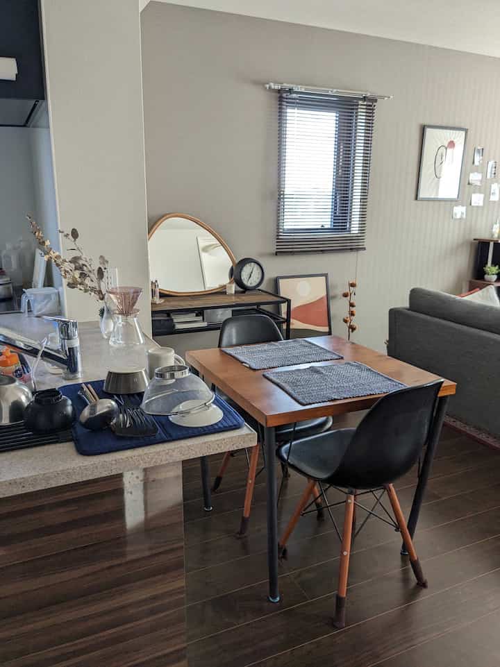 Natural wood and black kitchen and dining area with a neat and cozy space for two-person household