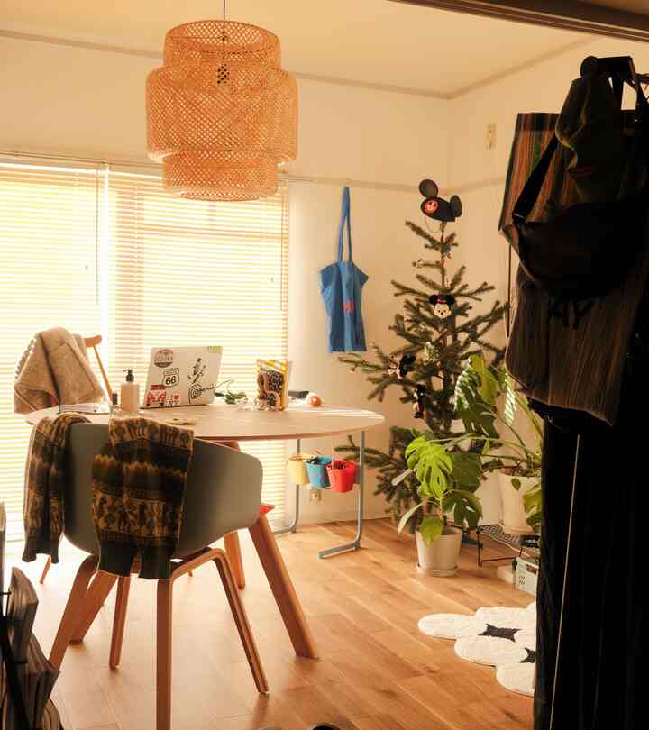 Natural color and white-toned dining room featuring a round dining table and pendant light with cozy atmosphere