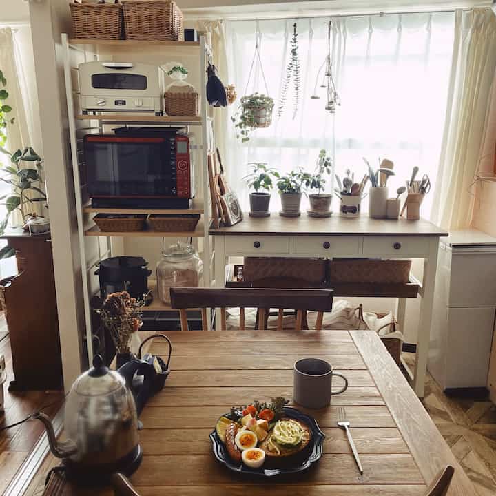 Wood tone and white cafe-style two-person dining space with soft natural light creating a warm atmosphere