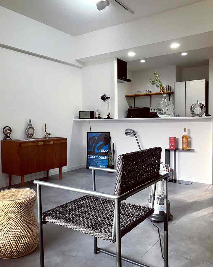 White and gray toned kitchen space featuring mid-century modern furniture and simple decor creating a clean atmosphere