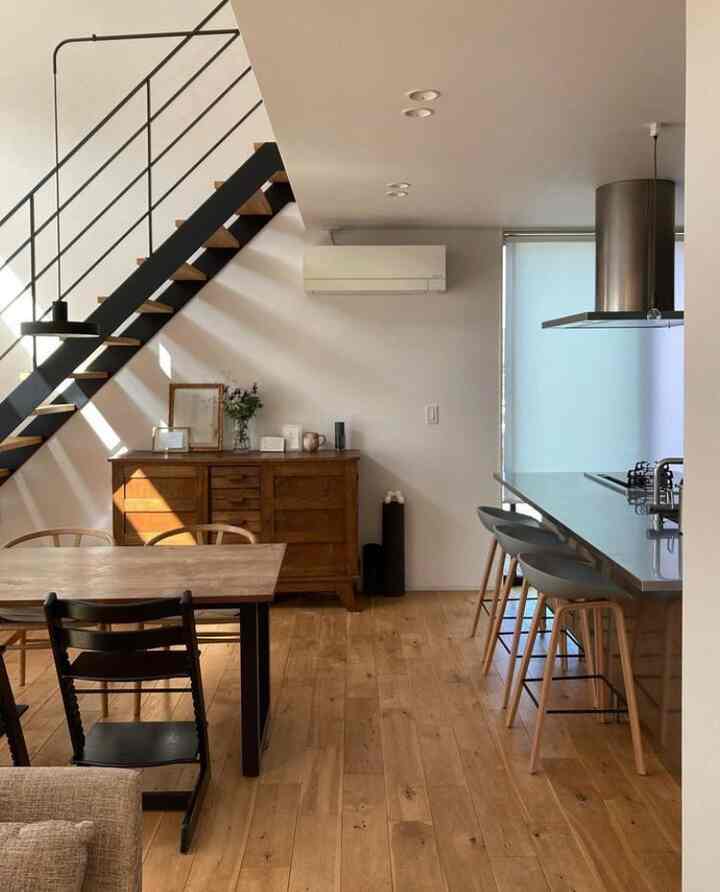 Wood tone and white toned dining room featuring modern dining table and chairs with a clean atmosphere