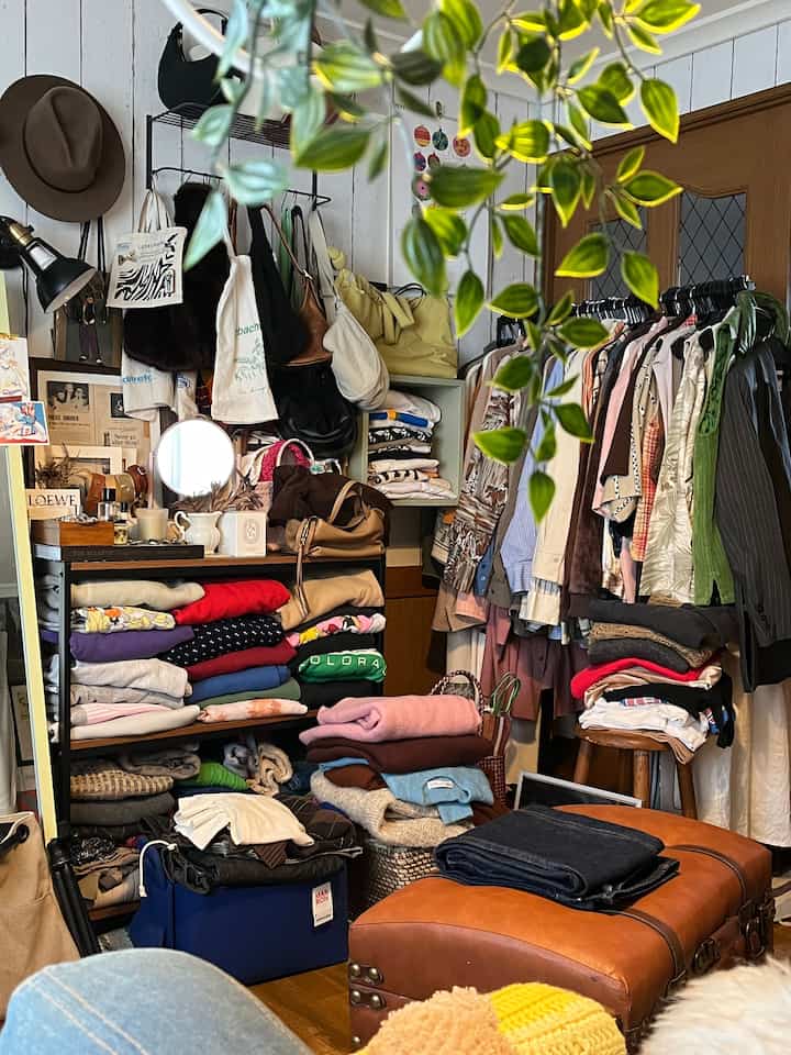 Natural brown-toned storage space with neatly hung and folded clothes in a closet-like setting