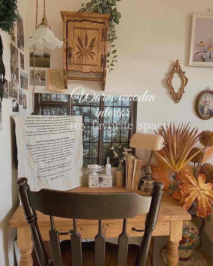 Warm wood tone natural modern home office space featuring wooden desk, vintage lamp, and plants creating a cozy Korean interior