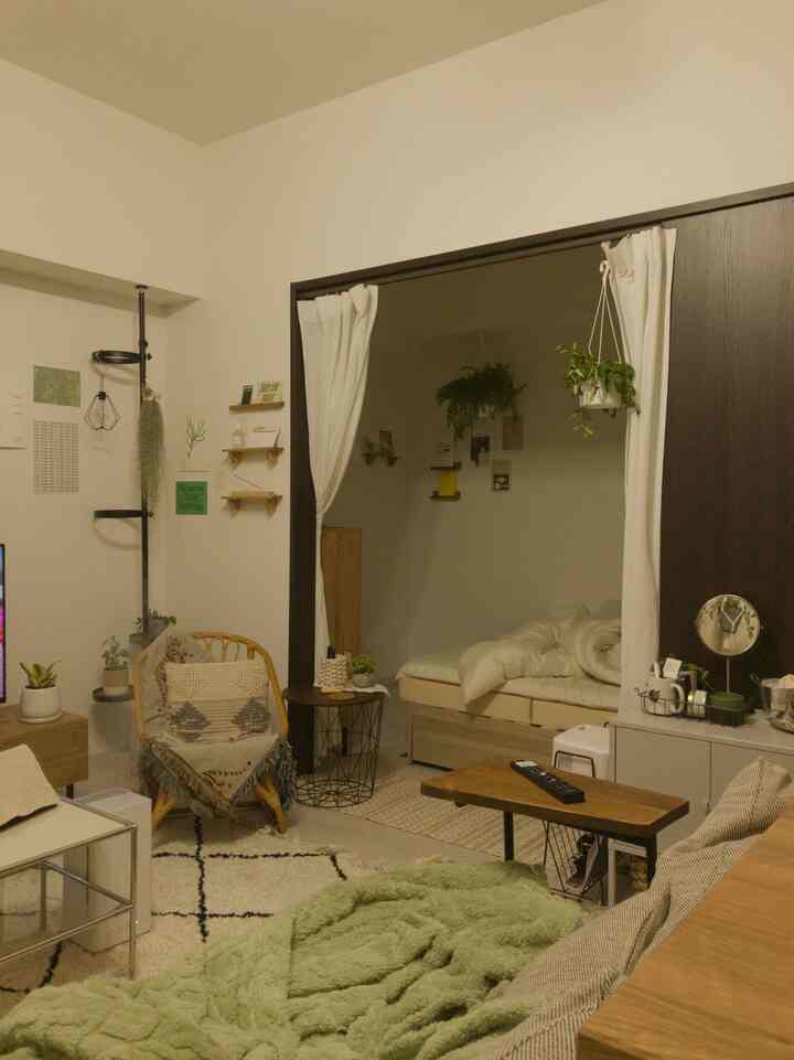 ブラウンの木目調とホワイトを基調とした1LDKのリビングと寝室空間、自然要素が配された雰囲気のあるインテリア