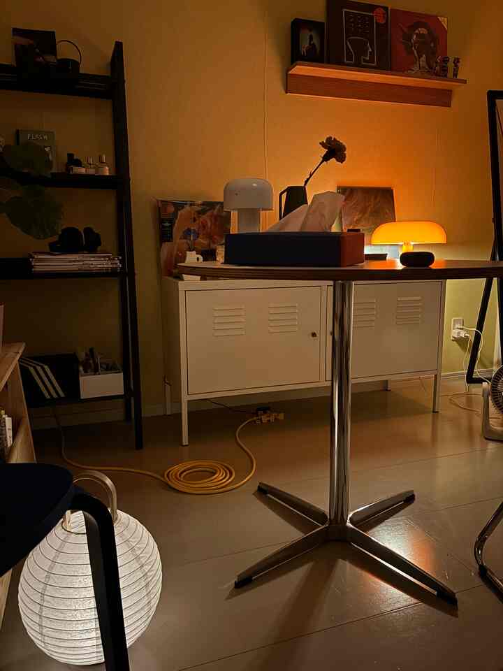 Warm beige-toned living room featuring a table lamp and floor lamp creating a cozy atmosphere