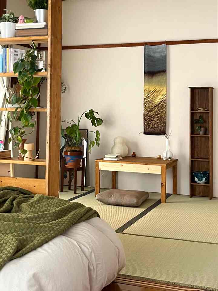 Natural-toned tatami room featuring wooden furniture and plants, creating a cozy Japanese-style interior