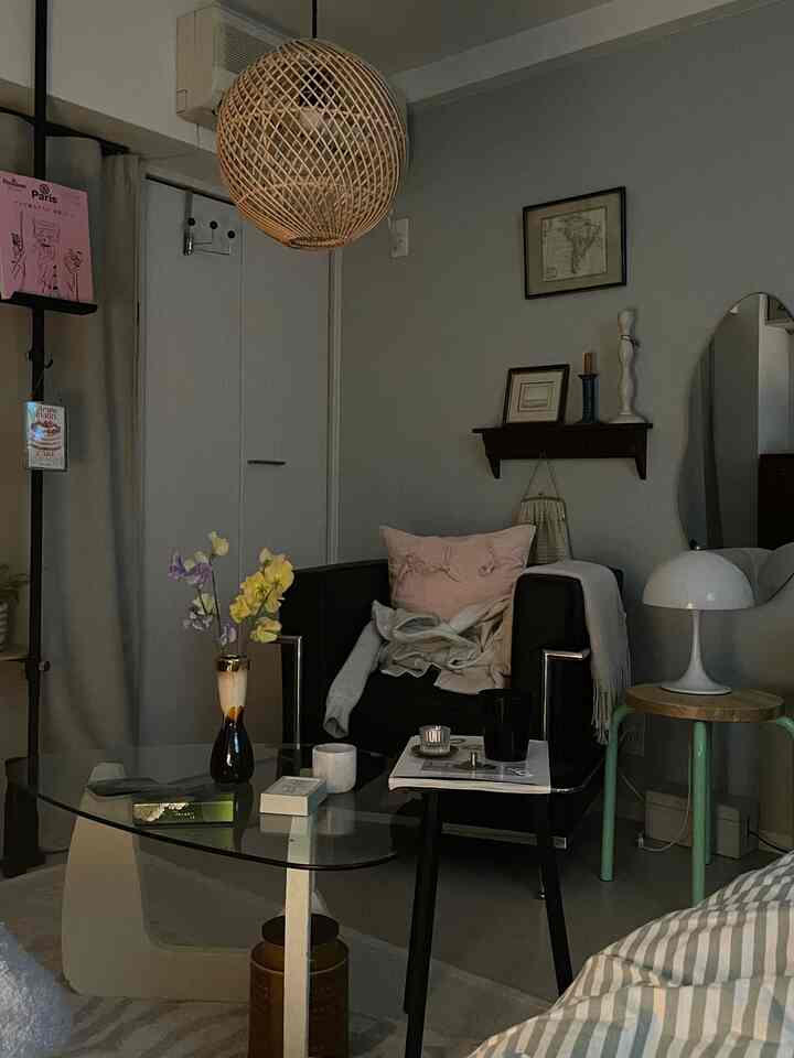 Gray-toned living room with modern black armchair and glass coffee table creating a cozy atmosphere