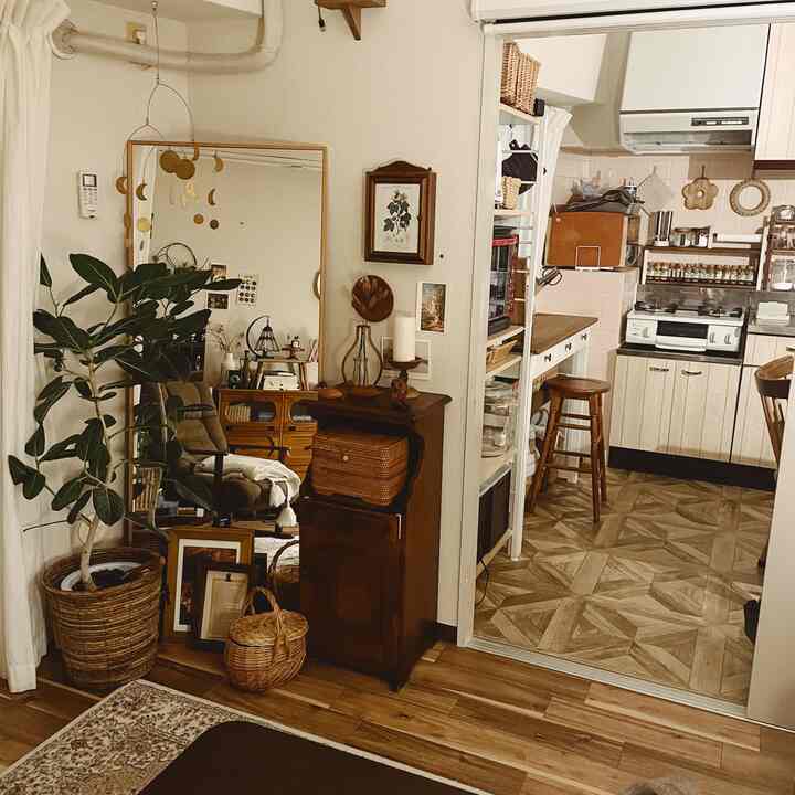 Cozy two-person living and kitchen space featuring natural wood tones and vintage decor elements