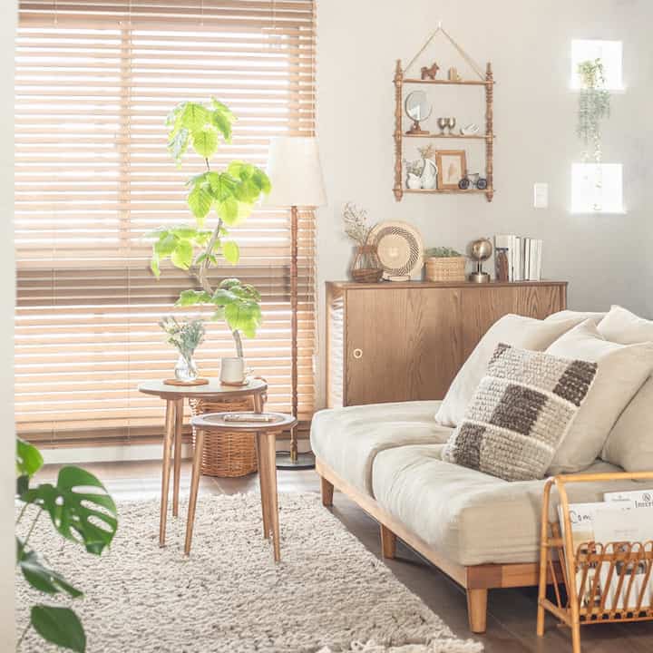 Natural brown and beige toned living room featuring wooden furniture and plush sofa with cozy atmosphere