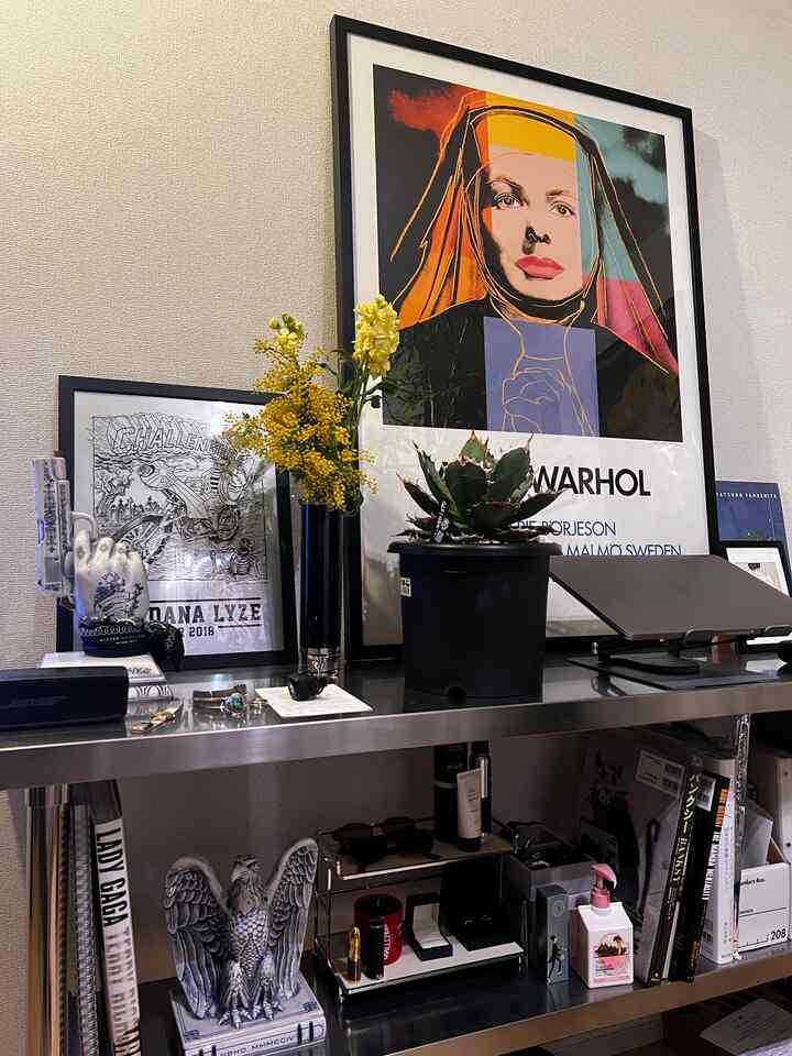 黄色い花とシルバーのメタル棚が配置されたコンテンポラリーなインテリア小物のある空間