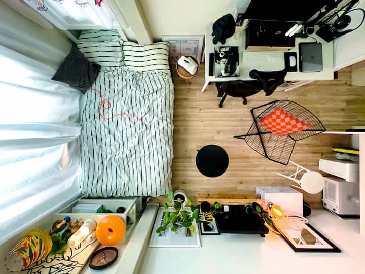 White-walled 6-tatami studio apartment with wooden floor, featuring bed and desk for a cozy single household space