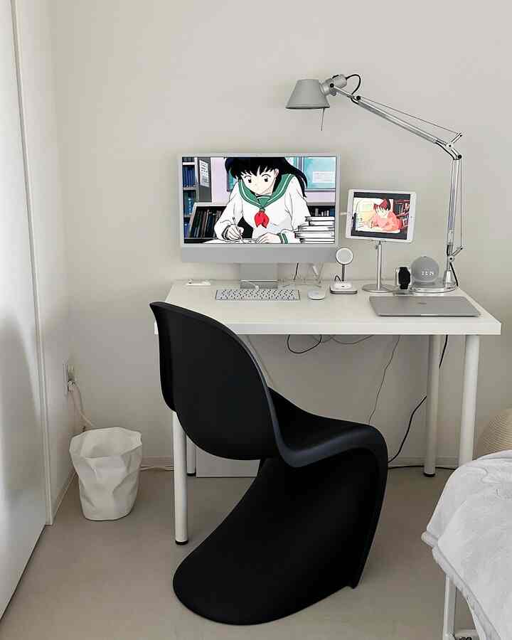 Monotone toned clean home office space featuring a white desk and black chair optimized for remote work