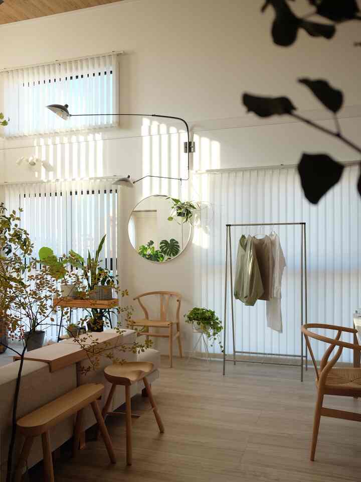 Natural tone living room featuring wooden furniture and plants with a comfortable modern atmosphere