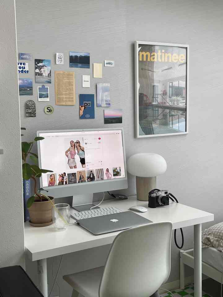 White and gray toned home office featuring a desk with computer and accessories in a simple modern design