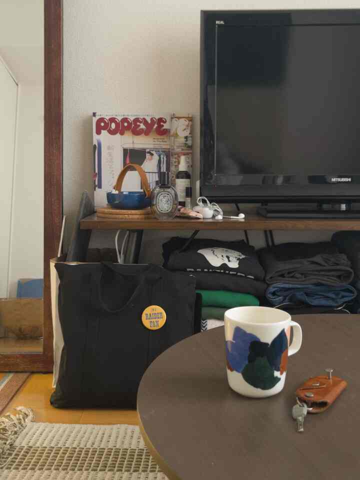 Cozy living room featuring brown wooden furniture and black accessories, with a subtle vintage vibe and compact layout