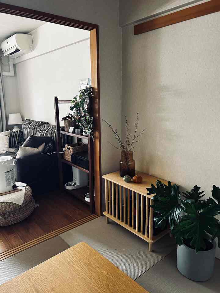 Natural color and wood tone tatami room featuring bamboo side table and plants with a calm atmosphere