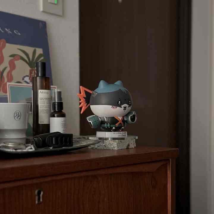 Natural style entrance with a dark wood tone storage cabinet featuring a cute character figurine