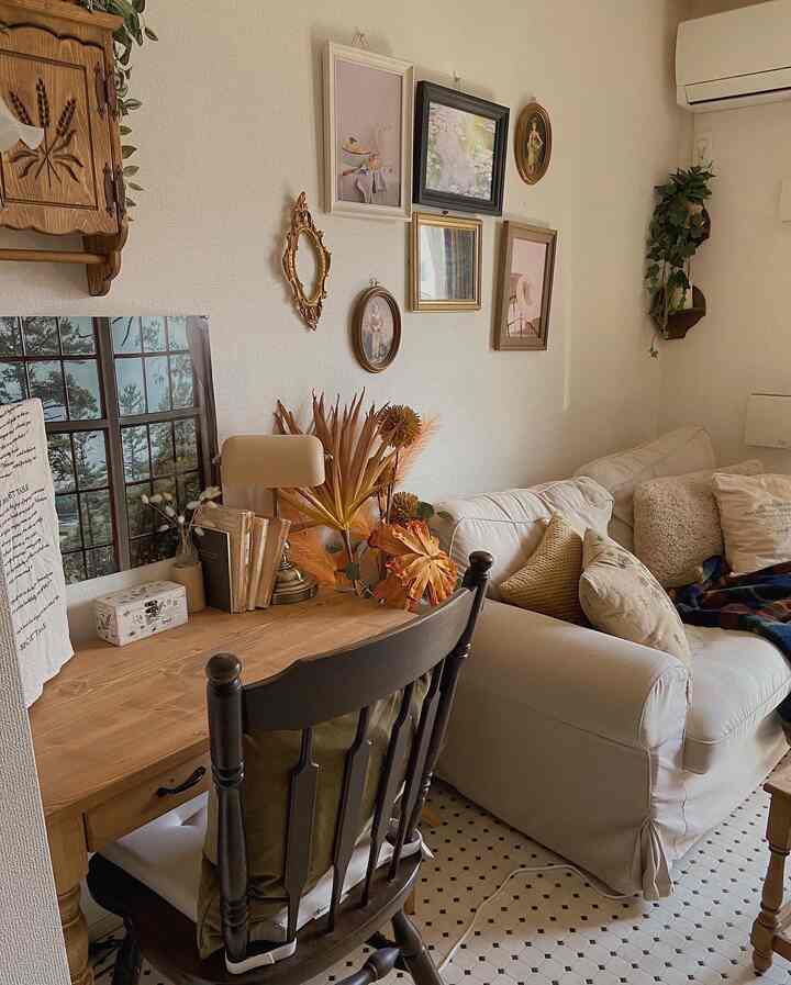 Cozy living room in natural brown and beige tones featuring a wooden desk and white sofa with warm ambiance