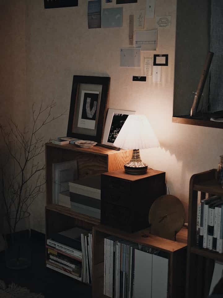 A calm living room corner space featuring warm wood tones and indirect lighting