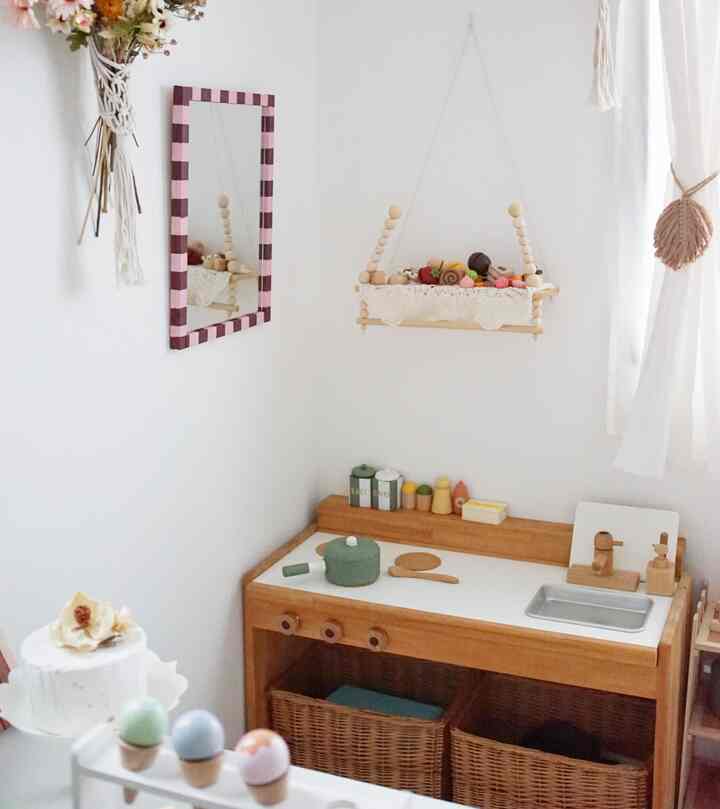 ナチュラルな木目調と白を基調とした子供部屋、木製のおもちゃとままごとキッチンが配された雰囲気のあるインテリア