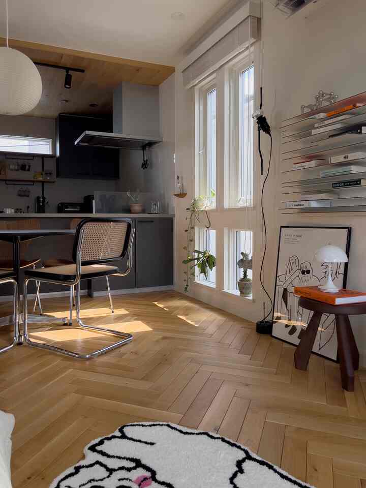 Bright wood-tone and black kitchen with dining chairs in a natural modern kitchen space