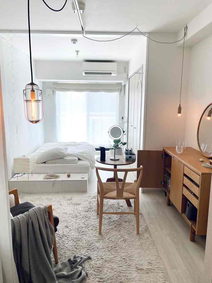 Bright white and natural wood tone 6-tatami bedroom featuring wooden furniture and simple decor creating a harmonious space