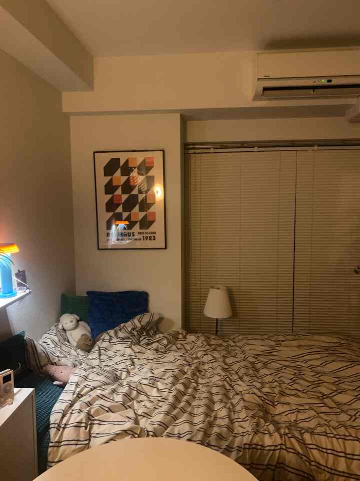 Natural white and beige 6-tatami bedroom featuring blue cushions and blanket creating cozy atmosphere