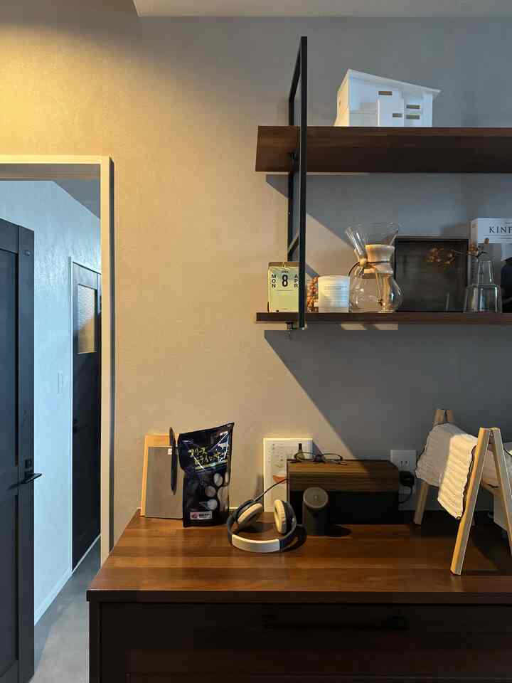 Cozy home cafe table area with brown wood shelves and matte gray wall background