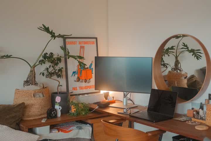 Natural tone workspace with wooden desk and plants, a cozy vanity and work area
