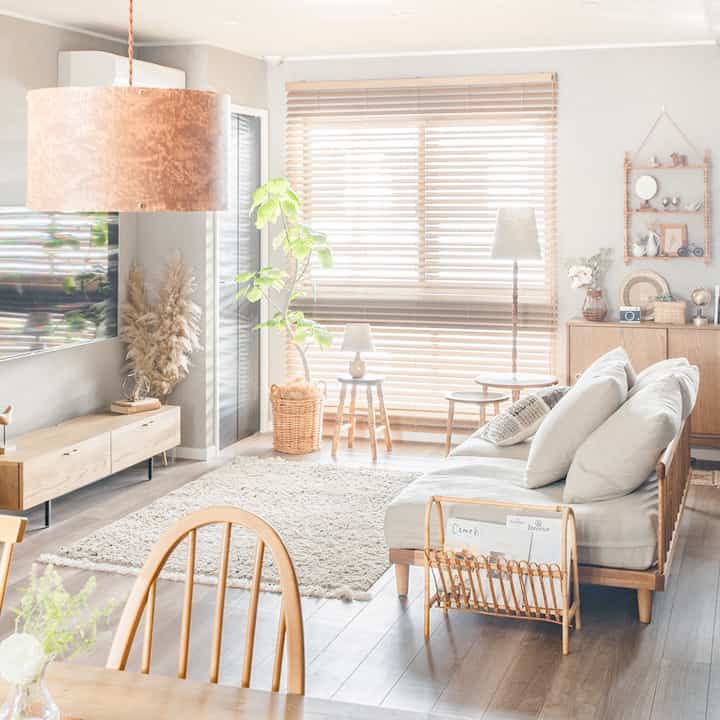 Bright beige and wood-tone living and dining room featuring natural wood furniture and a cozy rug, creating a warm and natural modern atmosphere