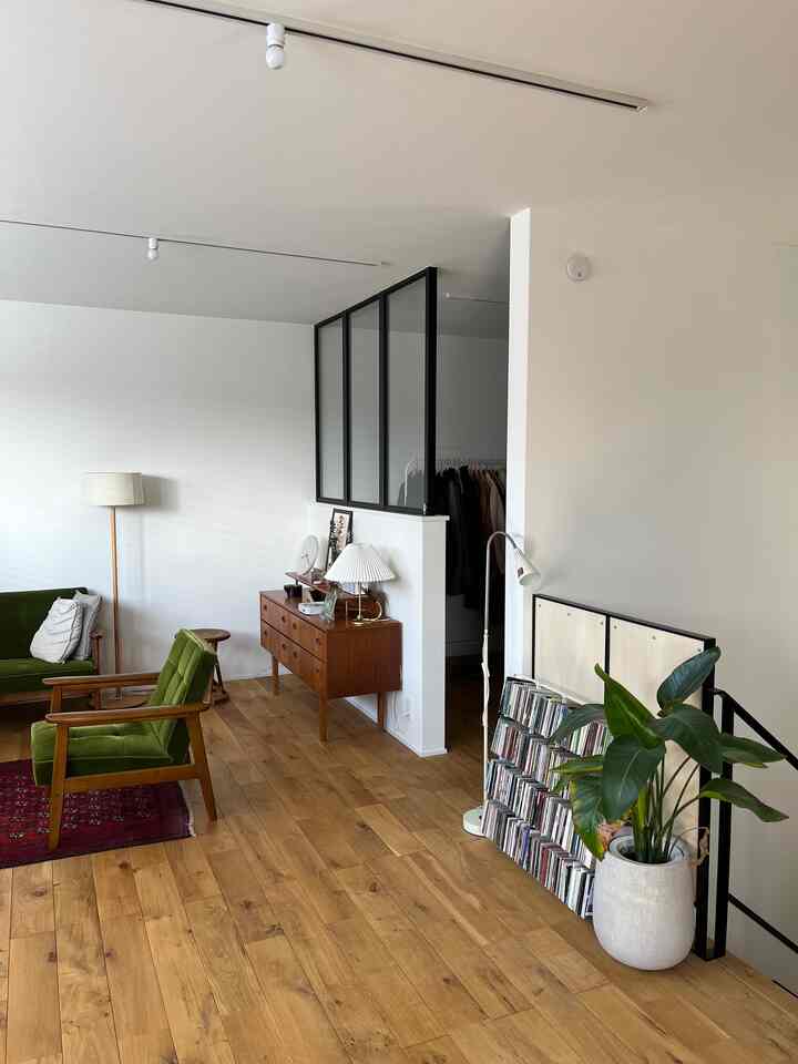 Bright and open living room featuring natural wood tones and modern furniture arrangement