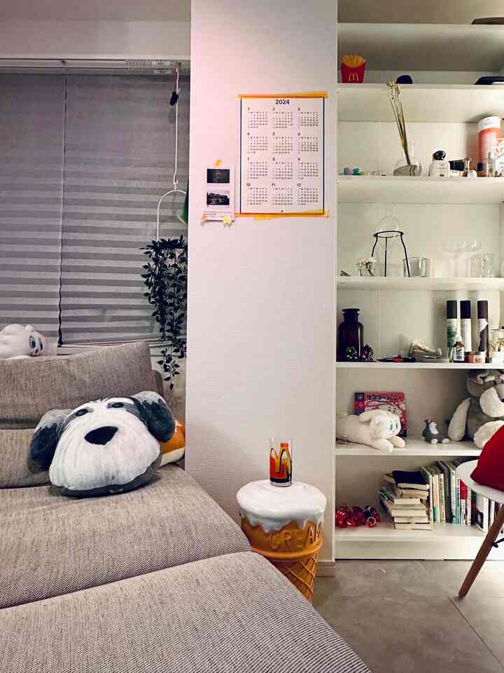 Beige sofa and white walls with a bookshelf in a cozy living room space
