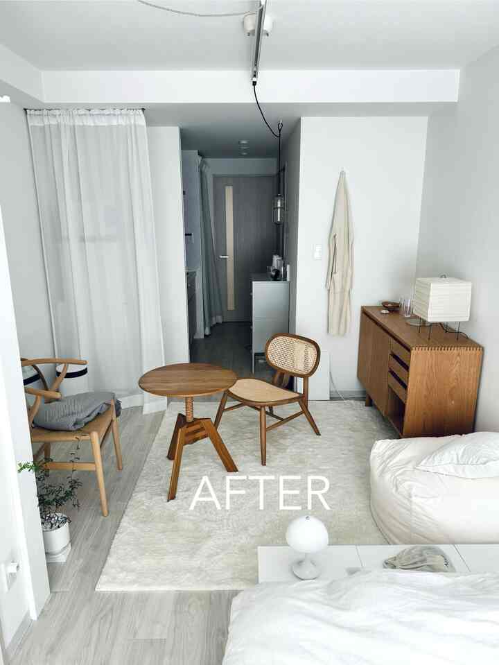 Wood tone and white compact living room featuring natural material furniture and a bean bag creating a cozy interior