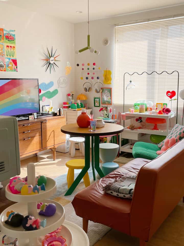 Bright and colorful mid-century modern living room featuring an orange sofa and diverse decor for a cozy atmosphere